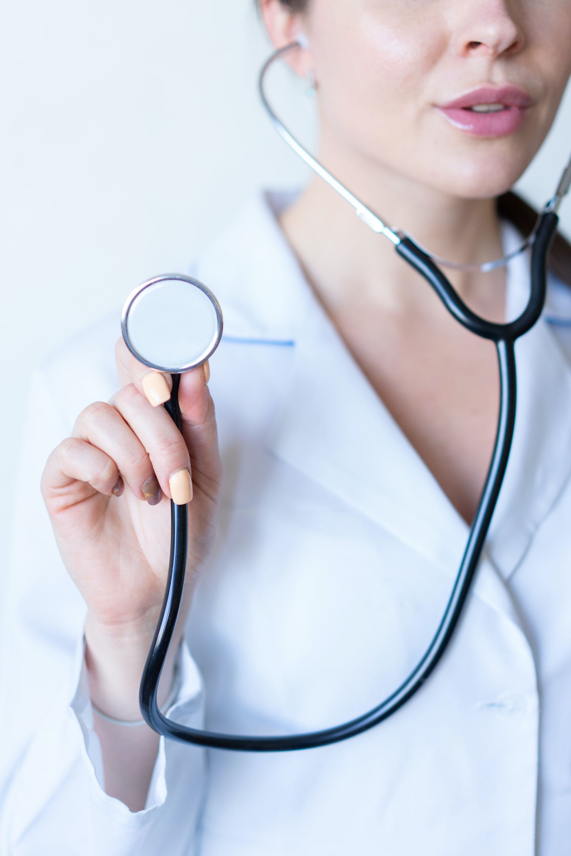 a clinician holding a stethoscope