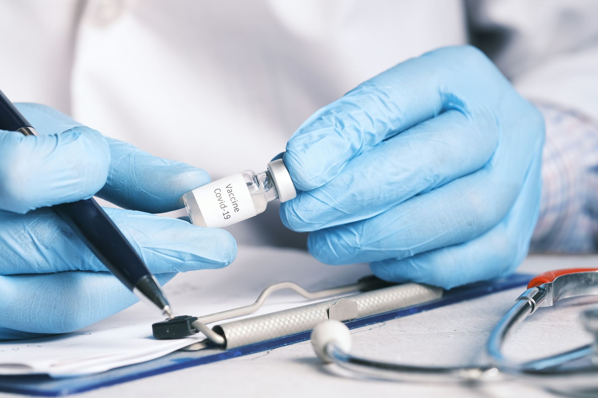 a clinician holding a vaccine vial